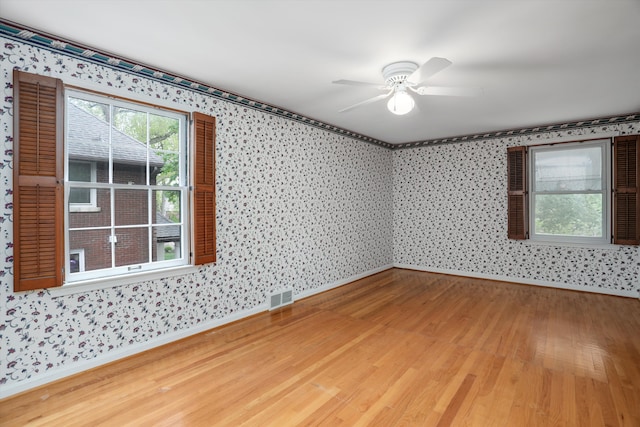 1133 Balfour St, Grosse Pointe Park, MI 48230 - empty room with wallpapered walls, baseboards, light wood-style flooring, and ceiling fan