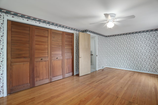 1133 Balfour St, Grosse Pointe Park, MI 48230 - unfurnished bedroom with wallpapered walls, light wood-style floors, a ceiling fan, and baseboards