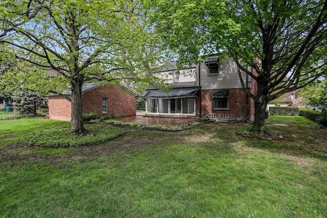 1133 Balfour St, Grosse Pointe Park, MI 48230 - rear view of house with brick siding and a lawn