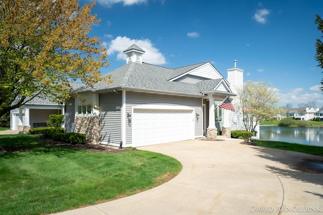 view of front facade with a garage, driveway, a front lawn, roof with shingles, and a chimney