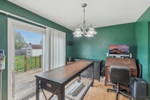 office area featuring a chandelier and wood finished floors