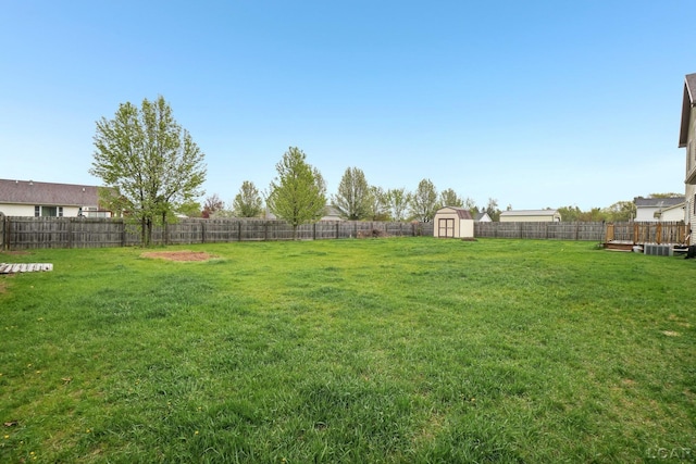 view of yard with a storage shed, an outdoor structure, and a deck