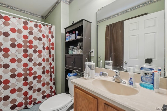 bathroom featuring vanity, toilet, and curtained shower