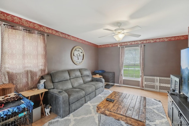 living area featuring ceiling fan and light wood-style floors