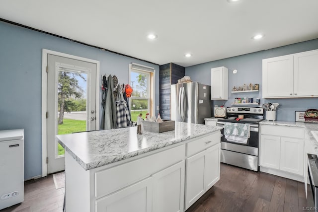 kitchen with appliances with stainless steel finishes, open shelves, white cabinets, and recessed lighting
