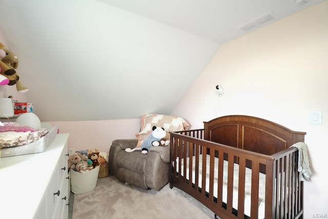 bedroom with lofted ceiling and light colored carpet