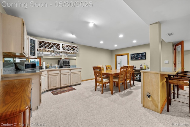 1162 Heights Rd, Lake Orion, MI 48362 - dining room featuring bar with sink, light carpet, recessed lighting, and baseboards