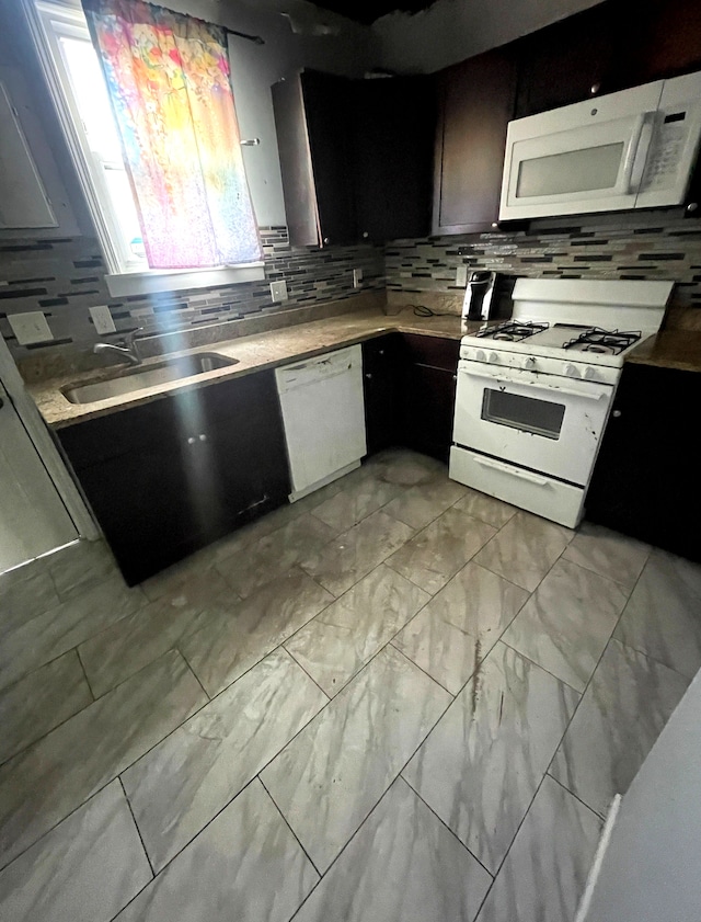 1714 Woodland St, Hamtramck, MI 48212 - kitchen featuring white appliances, a sink, tasteful backsplash, light countertops, and light marble finish floors