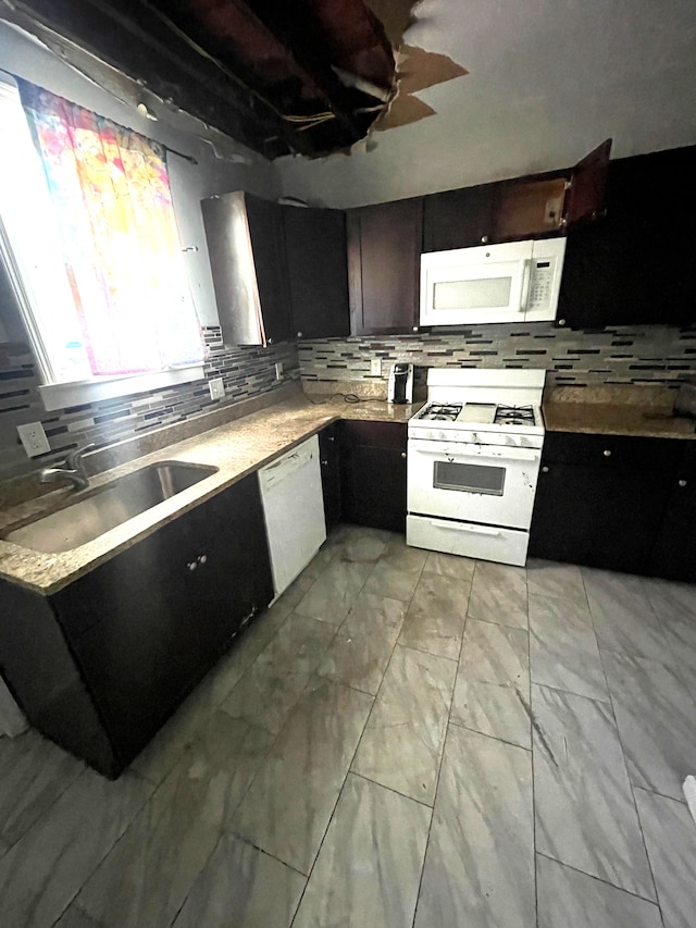 1714 Woodland St, Hamtramck, MI 48212 - kitchen with white appliances, a sink, decorative backsplash, light marble finish floors, and light countertops
