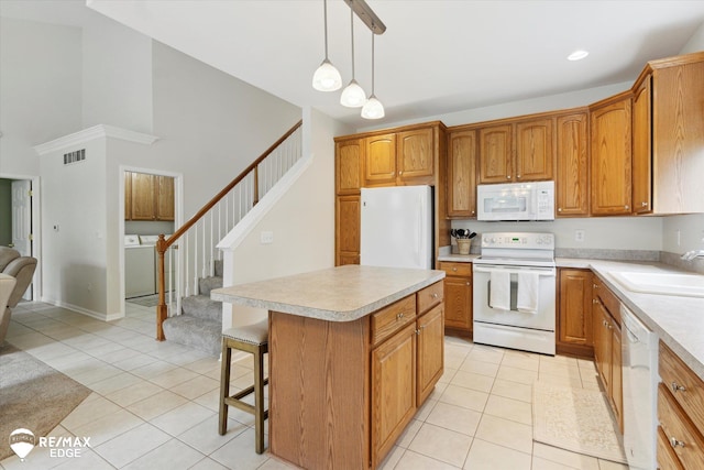 4433 Sunset Blvd, Grand Blanc, MI 48439 - kitchen featuring white appliances, a sink, light countertops, light tile patterned floors, and recessed lighting