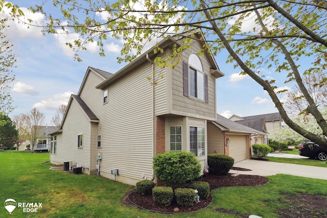 4433 Sunset Blvd, Grand Blanc, MI 48439 - view of home's exterior featuring concrete driveway, a garage, a lawn, and brick siding