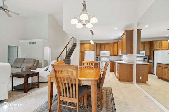 4433 Sunset Blvd, Grand Blanc, MI 48439 - dining space featuring light tile patterned floors, stairway, recessed lighting, a chandelier, and ceiling fan