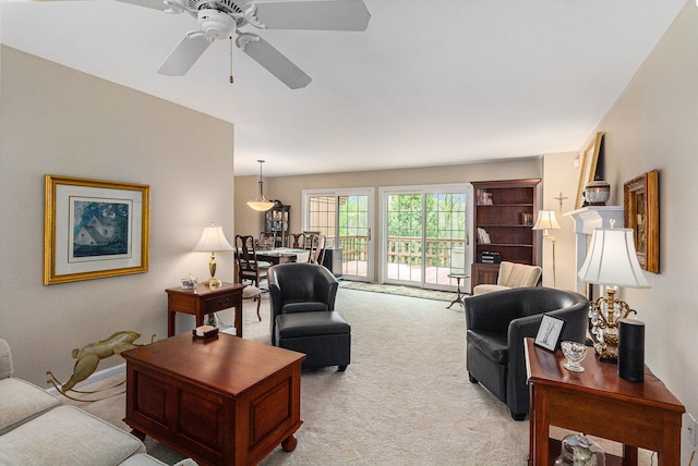 living room featuring carpet flooring and a ceiling fan
