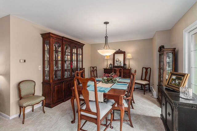 dining area with light colored carpet and baseboards