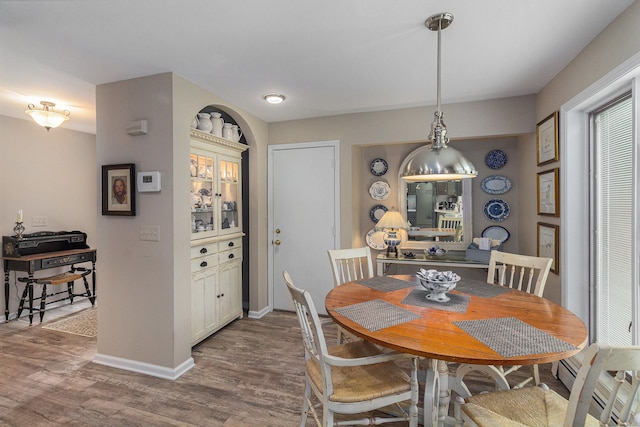 dining room with dark wood-style floors and baseboards