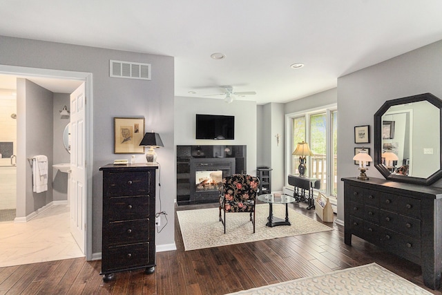 bedroom with a fireplace, dark wood-style flooring, recessed lighting, and baseboards