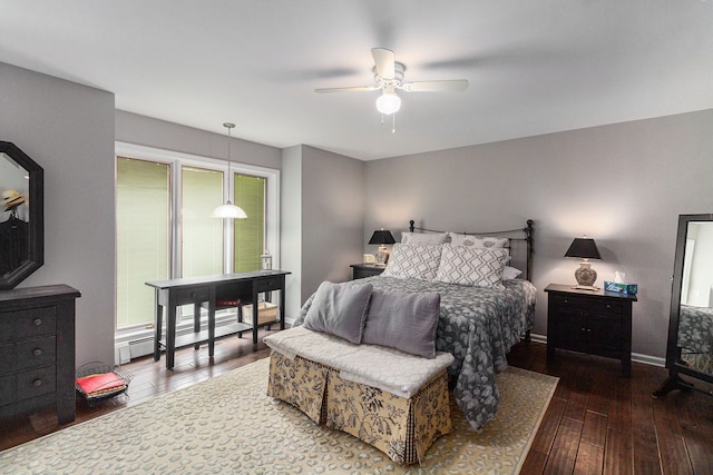 bedroom with wood-type flooring, baseboard heating, a ceiling fan, and baseboards