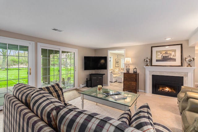 living area with carpet flooring, a fireplace, and a baseboard heating unit