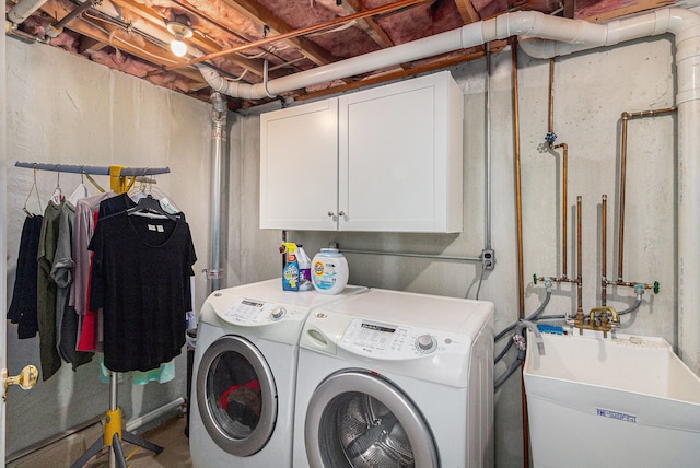 washroom with washer and dryer and cabinet space