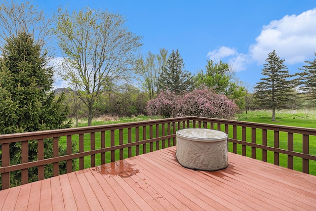 wooden terrace featuring a yard