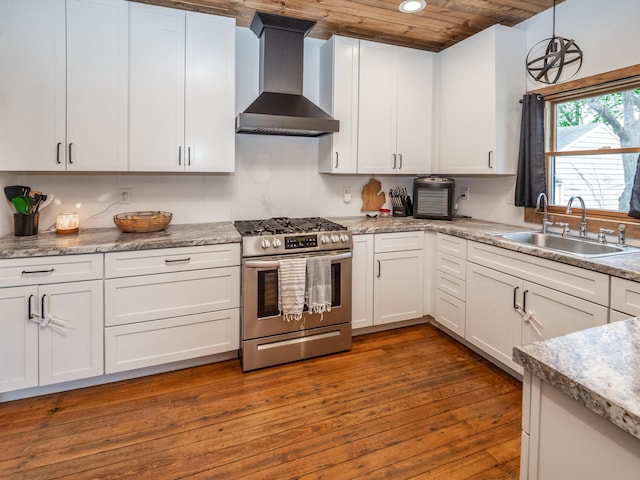 kitchen with stainless steel gas range oven, wall chimney exhaust hood, a sink, wood ceiling, and white cabinets