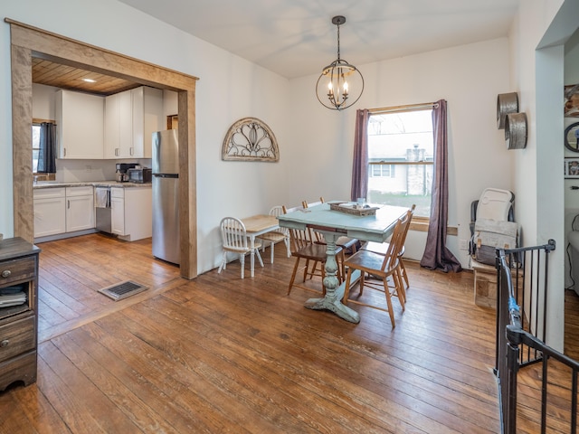 dining room featuring a chandelier and hardwood / wood-style flooring