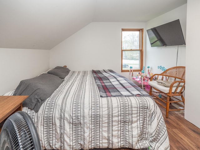 bedroom featuring wood finished floors and vaulted ceiling