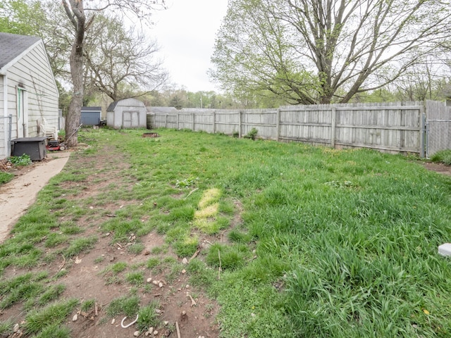 fenced backyard with a storage shed and an outbuilding