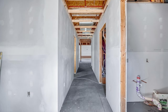 hall featuring concrete flooring