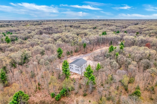 view from above of property featuring a heavily wooded area