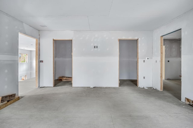 unfurnished bedroom with concrete floors