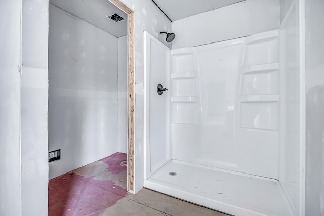bathroom featuring a stall shower and unfinished concrete floors