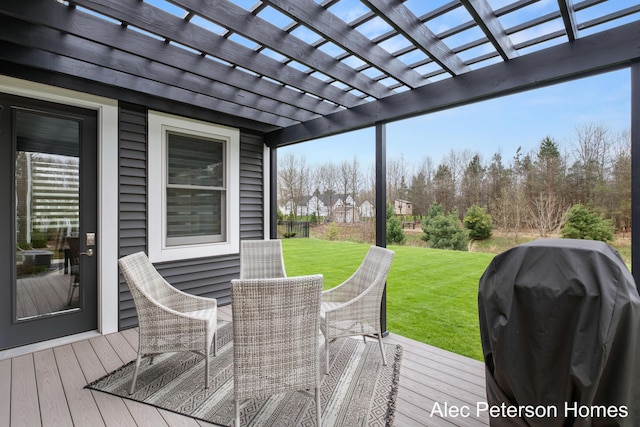 deck featuring a grill, a lawn, and a pergola