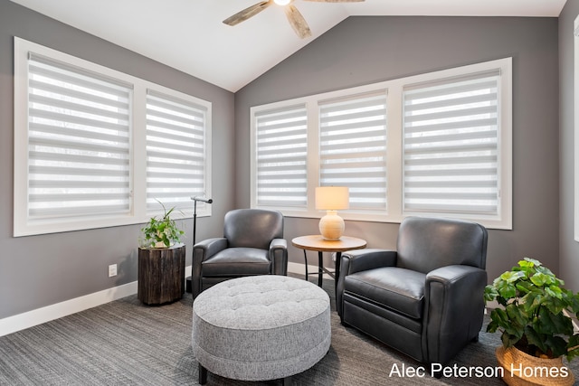 sitting room with a ceiling fan, plenty of natural light, lofted ceiling, baseboards, and carpet