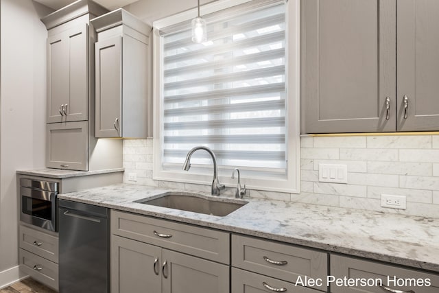 kitchen with a sink and gray cabinetry