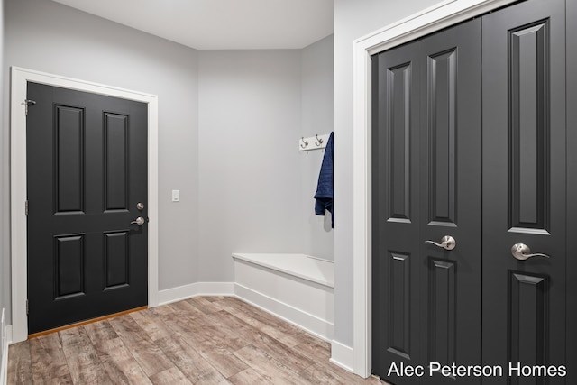 mudroom featuring light wood-style floors and baseboards