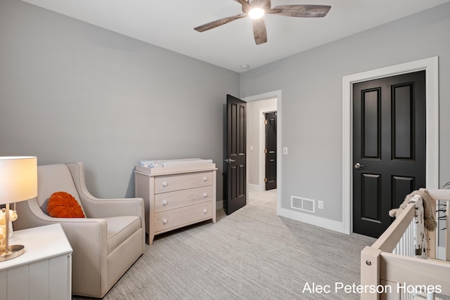 bedroom featuring light carpet, baseboards, and a ceiling fan