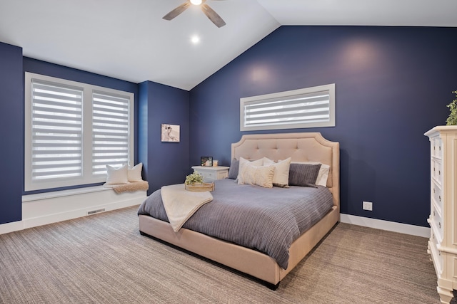 bedroom with lofted ceiling, multiple windows, ceiling fan, and baseboards