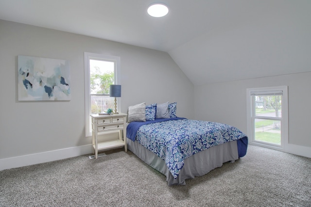 127 Bates St, Jackson, MI 49202 - bedroom with light colored carpet, multiple windows, vaulted ceiling, and baseboards