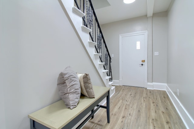 127 Bates St, Jackson, MI 49202 - entrance foyer with light wood finished floors, stairway, and baseboards