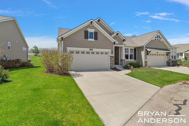craftsman-style home with driveway, stone siding, a front yard, and a garage