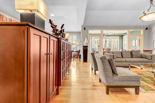 living area featuring light wood-style floors, ceiling fan, and recessed lighting