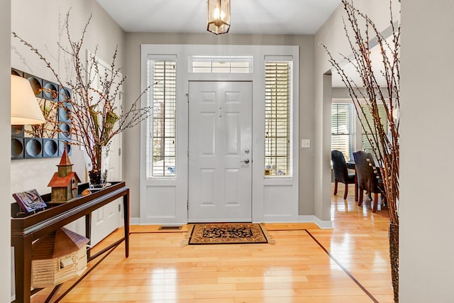 foyer entrance with hardwood / wood-style floors and baseboards