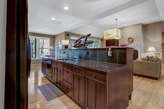 2700 Deep Forest Way, Fennville, MI 49408 - kitchen featuring a sink, light wood-style floors, open floor plan, dishwasher, and a kitchen island with sink
