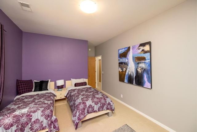 carpeted bedroom featuring baseboards