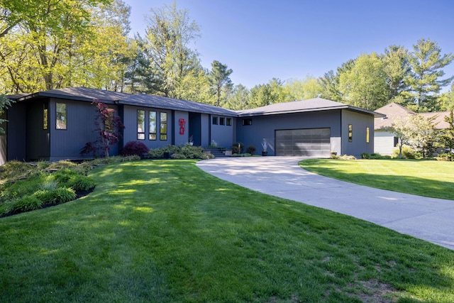 single story home featuring a garage, a front yard, and concrete driveway