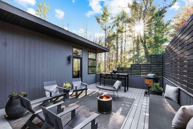wooden deck featuring a fire pit