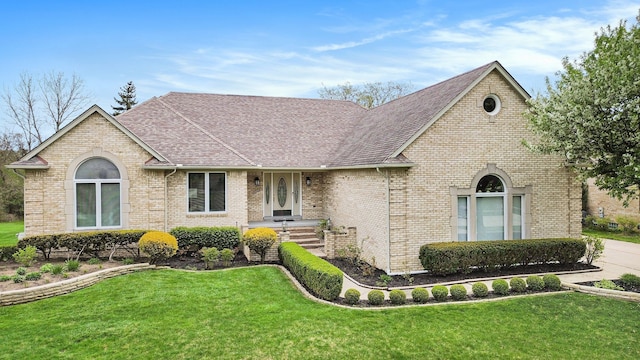 1204 Bradbury Dr, Troy, MI 48098 - view of front facade featuring a front lawn, brick siding, and a shingled roof