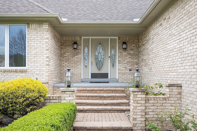 1204 Bradbury Dr, Troy, MI 48098 - property entrance with roof with shingles, brick siding, and covered porch
