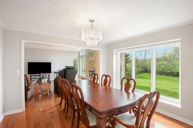 1204 Bradbury Dr, Troy, MI 48098 - dining room with a chandelier, baseboards, crown molding, and light wood-style flooring
